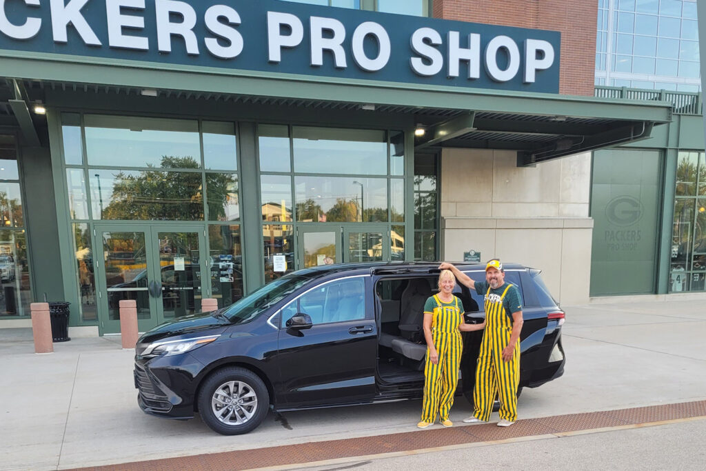 Wisconsin couple arriving at Lambeau Field in a Trusty Travels vehicle